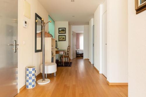 a hallway of a home with a hard wood floor at Lakeside-Apartment-1 Grand appartement familial avec 2 terrasses et vue panoramique in Vevey
