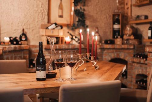 a wooden table with glasses of wine and candles at Hotel Sunshine Superior "ADULTS ONLY" Ischgl - Kappl in Kappl