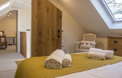 a bedroom with a bed with towels on it at Bridge Cottage in Luib