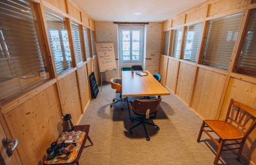 a room with a table and chairs and windows at Bigouden Makers in Pont-lʼAbbé
