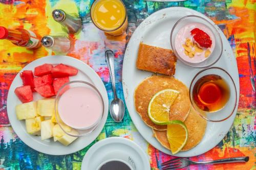 a table topped with plates of breakfast foods and drinks at Leyenda Boutique Hotel & Spa in Sámara