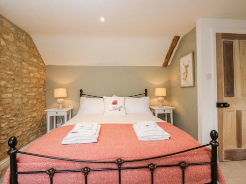 a bedroom with a large bed with two tables at The Lantern in Cheltenham
