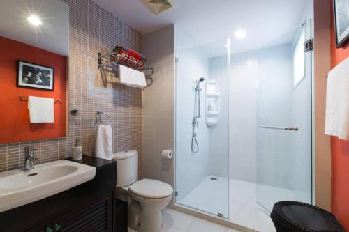 a bathroom with a shower and a toilet and a sink at Baan Sandao D201 in Hua Hin