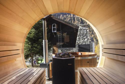 a room with two benches in front of a building at Polaris 1 006 - LUXE & SKI LIFT apartment 6 pers in Zinal