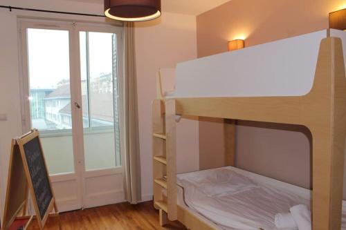 Ce lit superposé se trouve dans un dortoir doté d'une fenêtre. dans l'établissement Le Jane : Centre ville, Garage, Balcon, à Annecy