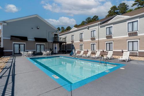 a swimming pool in front of a building at Quality Inn Phenix City Columbus in Phenix City