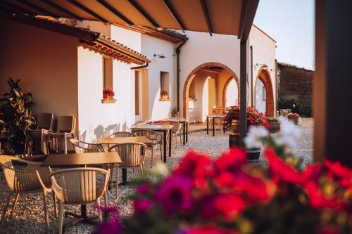 a patio with tables and chairs and flowers at Agriturismo Villa Adimari in Cerreto Guidi