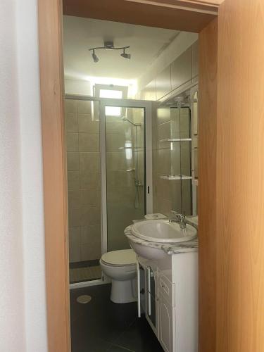 a bathroom with a toilet and a sink and a shower at MAKTUB SUNSET COTTAGE A in Paul do Mar