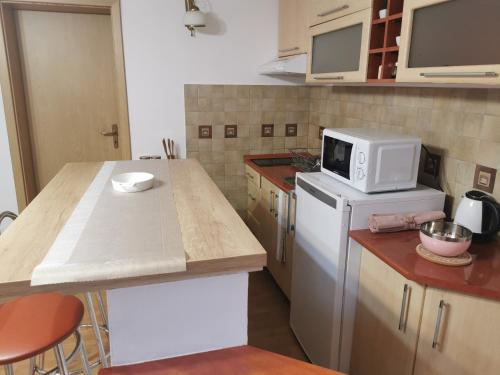 a kitchen with a microwave on top of a refrigerator at Casa Sabina in Mediaş