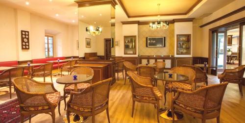 a restaurant with tables and chairs in a room at Hotel Il Chiostro by LVG Hotel Collection in Verbania