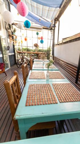 a blue table and chairs on a deck at Casa Tuxi in Rio de Janeiro