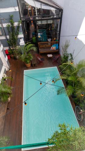 a large swimming pool on a balcony with plants at Casa Tuxi in Rio de Janeiro