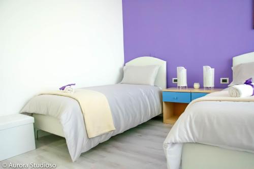 Postel nebo postele na pokoji v ubytování B&B L'incanto degli Artisti