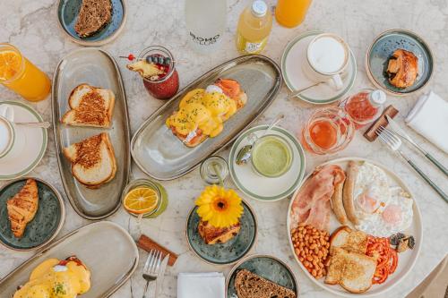 a table with plates of breakfast food on it at Boho Club in Marbella