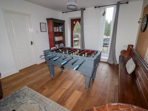 a room with a pool table in the middle of a room at The Chapel in Merthyr Tydfil