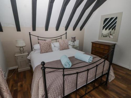 a bedroom with a black and white bed with pillows at The Chapel in Merthyr Tydfil