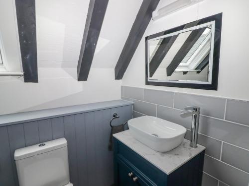 a bathroom with a white toilet and a sink at The Chapel in Merthyr Tydfil