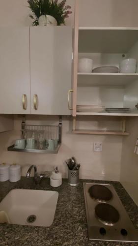 a kitchen with a sink and a counter top at יולי גולף in Caesarea