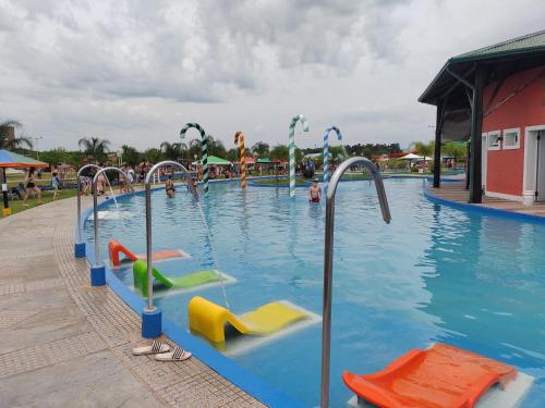 a large swimming pool with colorful slides in it at Cabaña Don Oscar in Federación