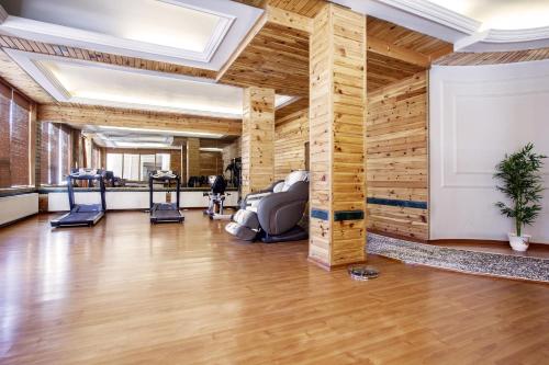 a room with a gym with wooden walls at The Grand Dragon Ladakh in Leh