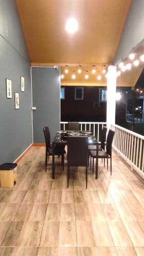 a dining room with a table and chairs on a balcony at บ้านไร่โฮมเทล ณ ปากช่อง in Ban Nong Takhain