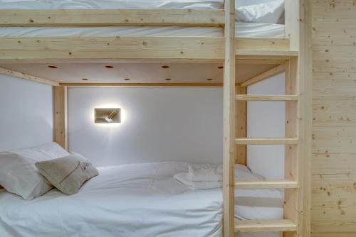 a bedroom with a bunk bed with a ladder at Echo du Pleney A204 in Morzine