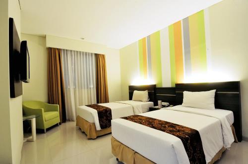 מיטה או מיטות בחדר ב-Pose In Hotel Solo