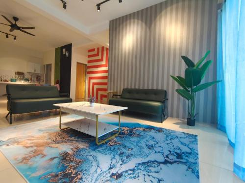 a living room with a white table and a blue rug at Pavilionvillie M1T584 by irainbow in Simpang Pulai