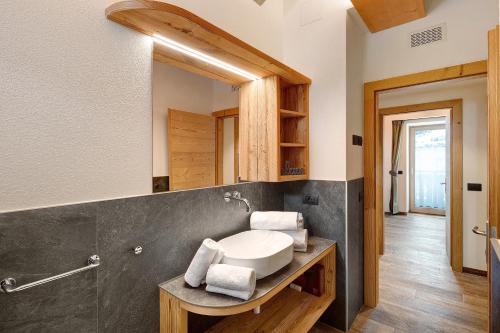 a bathroom with a sink and a mirror at Gemma Rosina's Home in Livigno