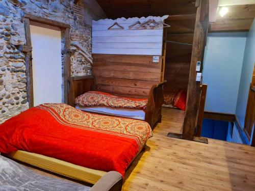 a bedroom with two beds in a log cabin at Villa de 7 chambres avec piscine privee jardin amenage et wifi a Saint Jean de Marsacq in Saint-Jean-de-Marsacq