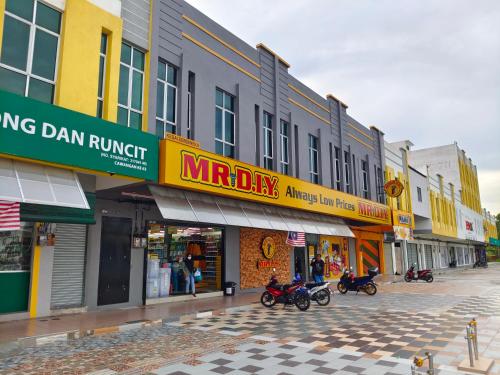 a street with many shops and motorcycles parked on a street at Pavilionvillie M1T584 by irainbow in Simpang Pulai