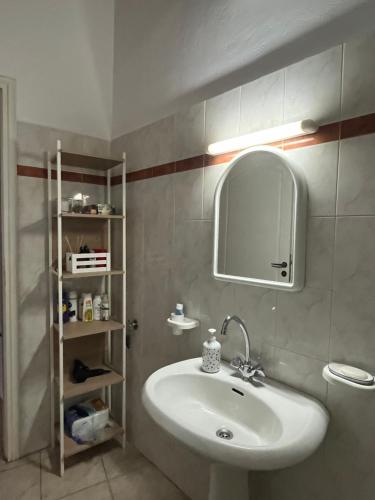 a bathroom with a sink and a mirror at House near the Athens Airport, Spata. in Spata