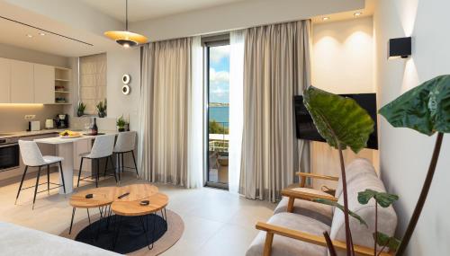 a living room and kitchen with a couch and a table at KALES SEA VIEW SUITES in Ierápetra