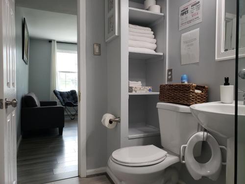 a bathroom with a white toilet and a sink at Private Duplex Near BWI/Easy Access to I95 in Linthicum Heights