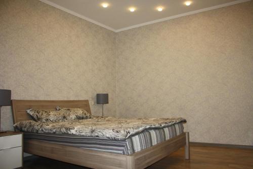 a bedroom with a bed in a room at Apartment Voykova 23 in Sochi