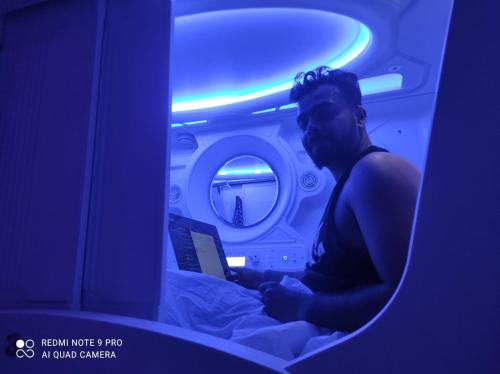 a man sitting in bed reading a book in an airplane at NAP CORNER - Napfor Sale - PRIV HOTELS in Male City