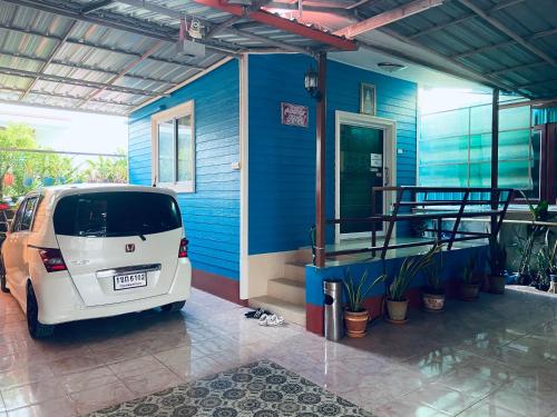 a small white car parked in front of a house at บุญจินดา รีสอร์ท in Ban Phayom