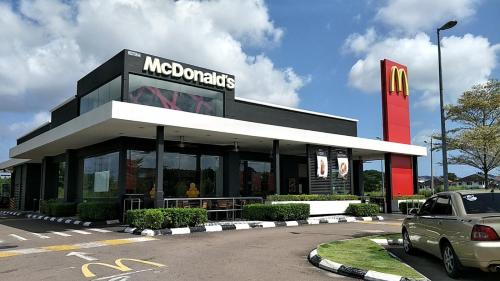 Um restaurante Mcdonalds com um carro estacionado em frente. em Idaman Maya em Keluang