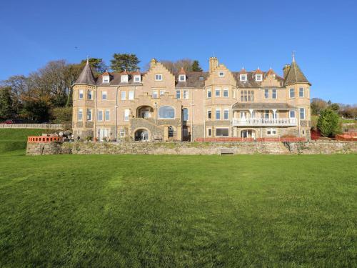 a large house with a large lawn in front of it at Bryn Mel Manor Straits View in Menai Bridge