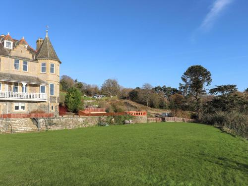 a large lawn in front of a large house at Bryn Mel Manor Straits View in Menai Bridge