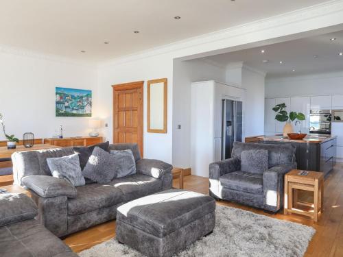 a living room with a couch and two chairs at Bryn Mel Manor Straits View in Menai Bridge