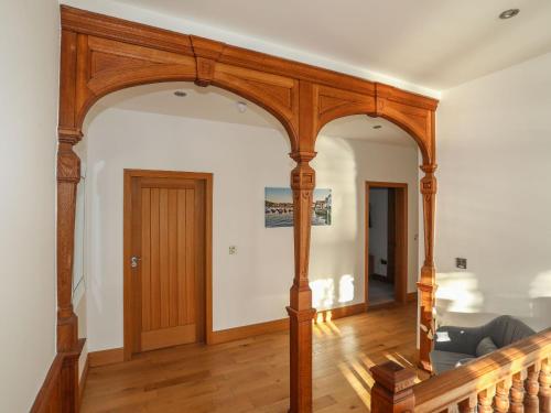 an archway in a living room with a wooden door at Bryn Mel Manor Straits View in Menai Bridge