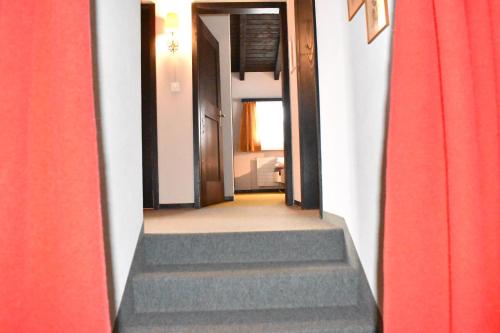 a hallway with stairs leading into a room at Arp (470 Bä) OG in Valbella