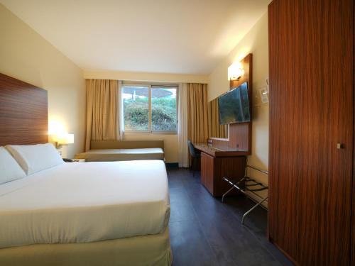 a hotel room with a large bed and a window at La Meridiana Bleisure Hotel in Perugia