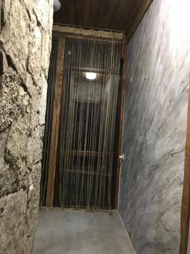 a door in a room with a stone wall at Guest house in Dilijan Haghartsin in Haghartsin
