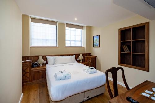 Postel nebo postele na pokoji v ubytování Limehouse Library Hotel
