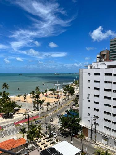 uma vista para a praia e para o oceano a partir de um edifício em Stúdio Beira Mar em Fortaleza