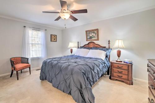 a bedroom with a bed and a ceiling fan at Country-Chic Home with Fire Pit, Steps to Lake! in New Concord