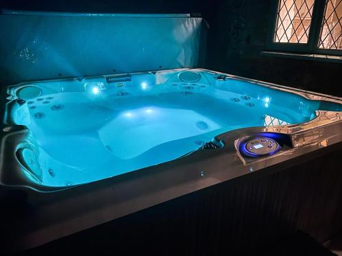 a blue bath tub in a room with a window at Riverside Cottage-uk41439 in Brandon
