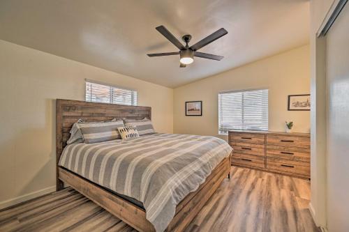a bedroom with a bed and a ceiling fan at Munds Park Cabin with Wraparound Deck and Grill! in Munds Park